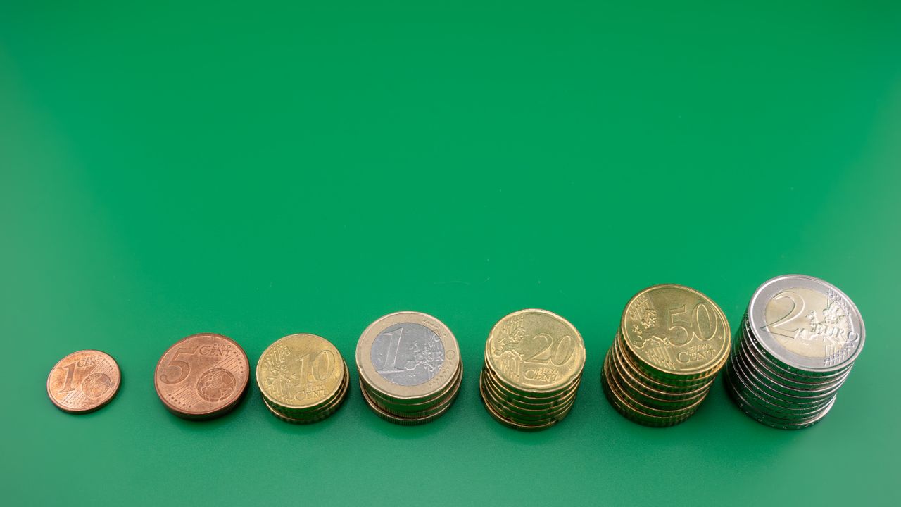 The Art of Drawing Readers In: Your attractive post title goes here Various euro coins stacked incrementally on a vibrant green background.